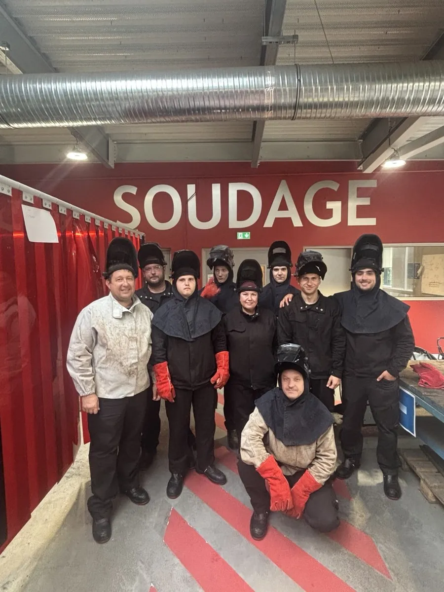 A group of Jobs Around welding trainees in welding gear in a workshop